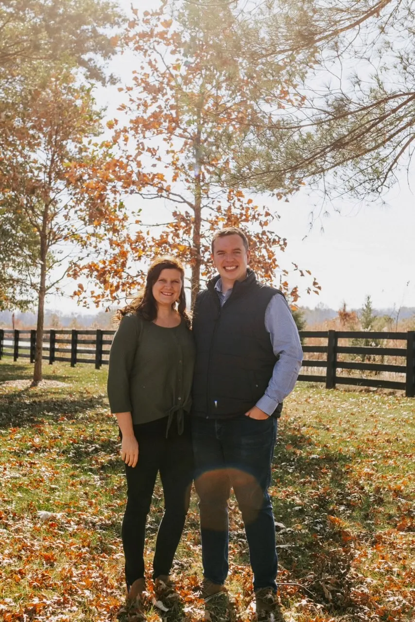 Michael and Ashley Kimble standing together outdoors in golden-hour light.